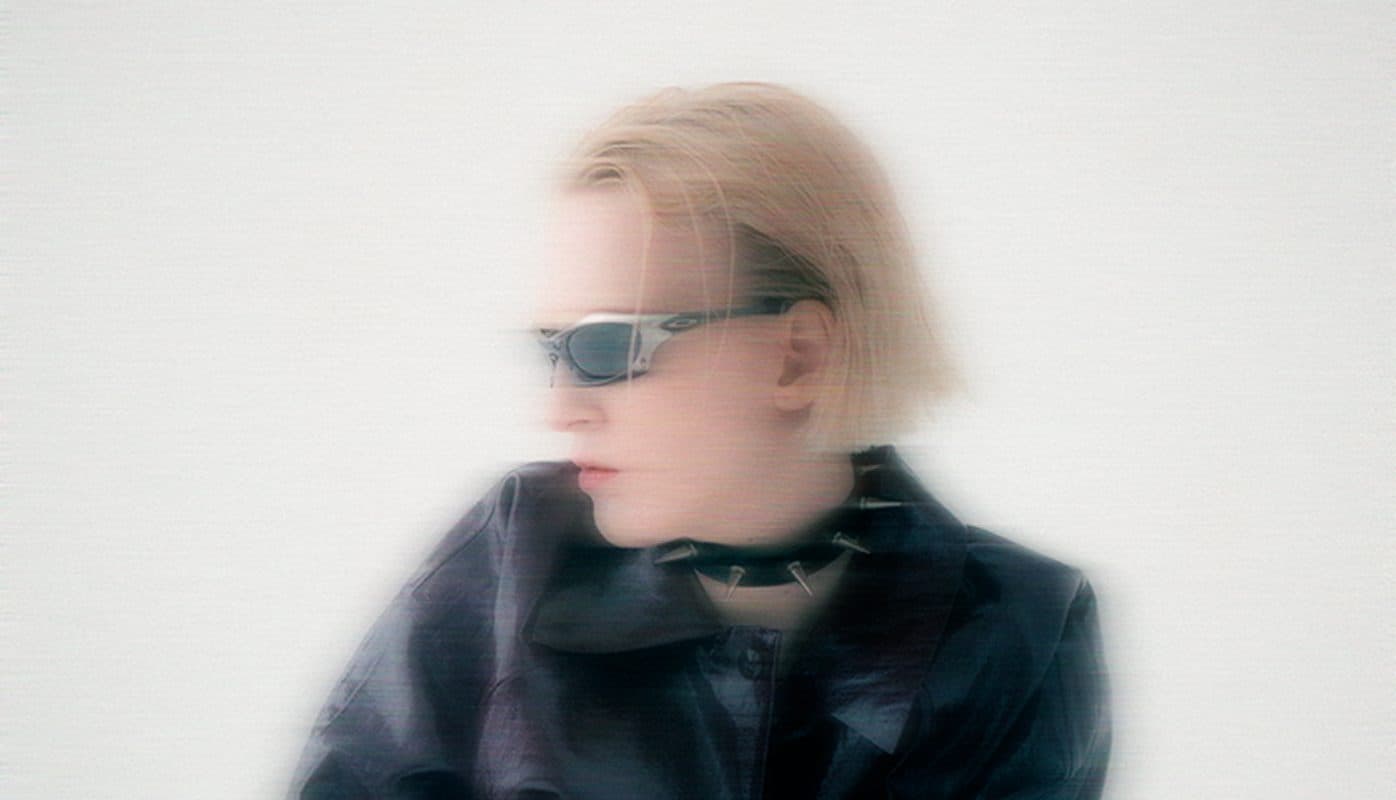 Motion-blurred portrait of a person in sunglasses and a leather jacket