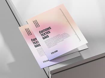 Two gradient flyers for Éditions Textes Gais lying on the edge of a grey table
